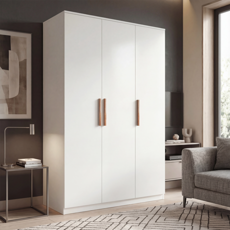 Three door plain white wardrobe in room setting with wooden handles and doors closed placed in a natural light