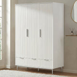 White three door wardrobe with lower drawers placed in room setting with soft neutral decor
