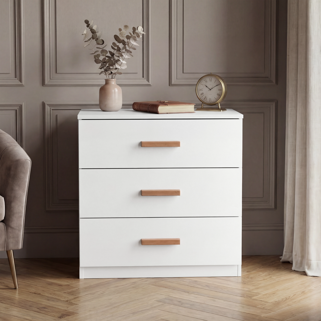 [White] Front view of white three drawer chest against neutral wall with smooth drawer fronts and flat top