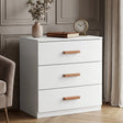 [White] three drawer chest placed in room beside window with clean lines and wooden horizontal handles