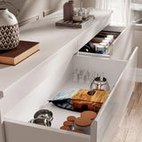 High Gloss Large 6 Drawer Chest of Drawers with open drawers showing organized storage of snacks, jars, and kitchen items in a modern bedroom setting.