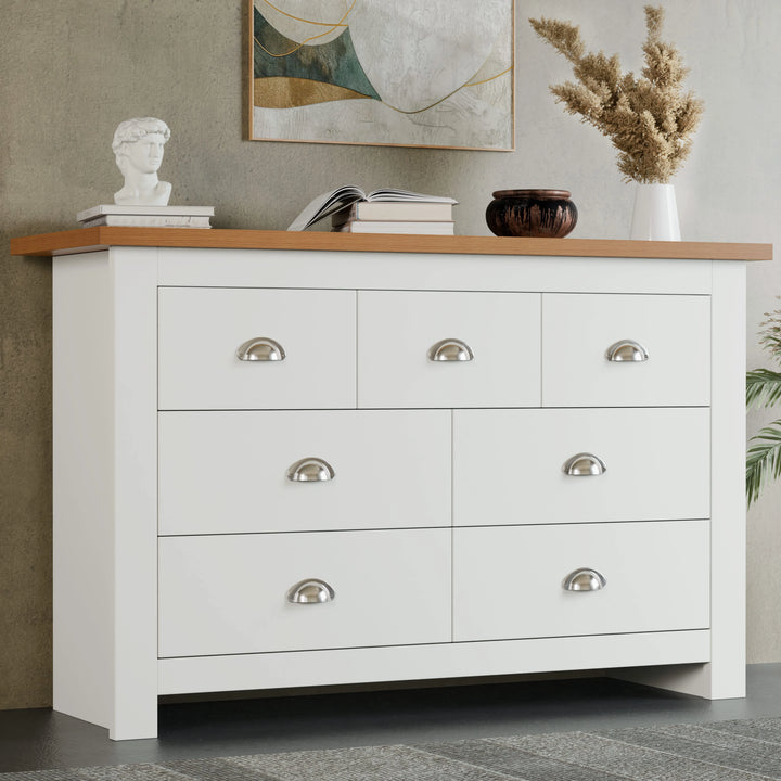 [White] Shaker 7 drawer wide chest front view with oak top and pampas grass in vase on top.