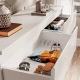 [white] high gloss chest top drawers open from above showing snacks jars and toiletries stored