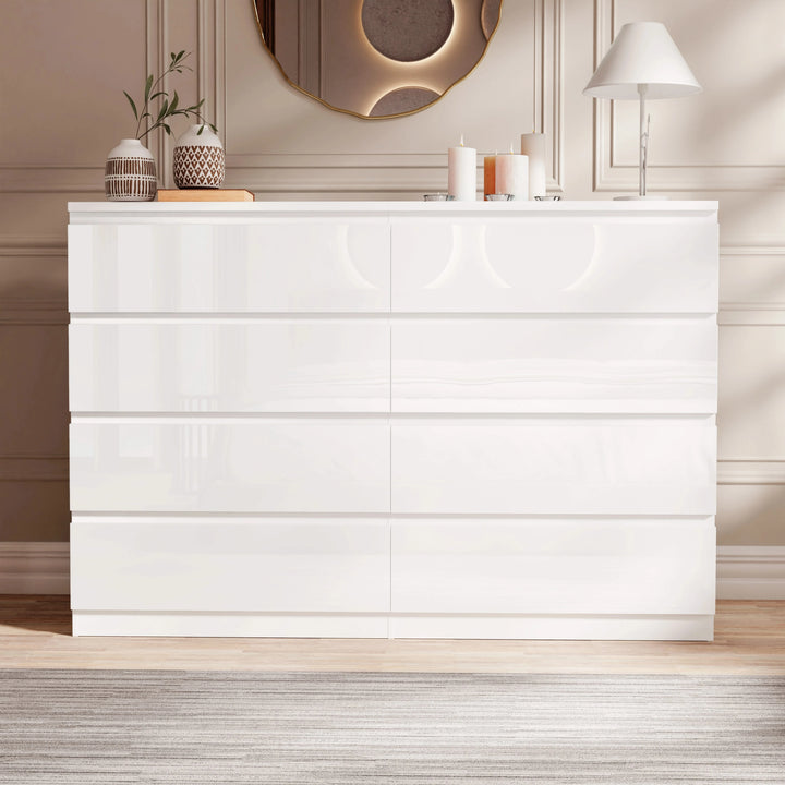 [White] high gloss wide chest of drawers front view closed under gold mirror with candles and lamp on top