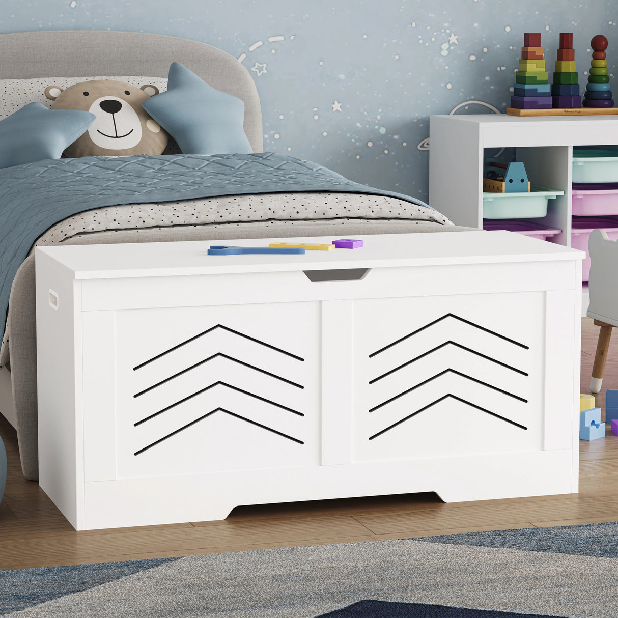 Toy Storage Box - Kids Storage Chest Blanket Box with Safety Hinges in white with arrow design, placed in a child's bedroom next to a bed and toy shelf.