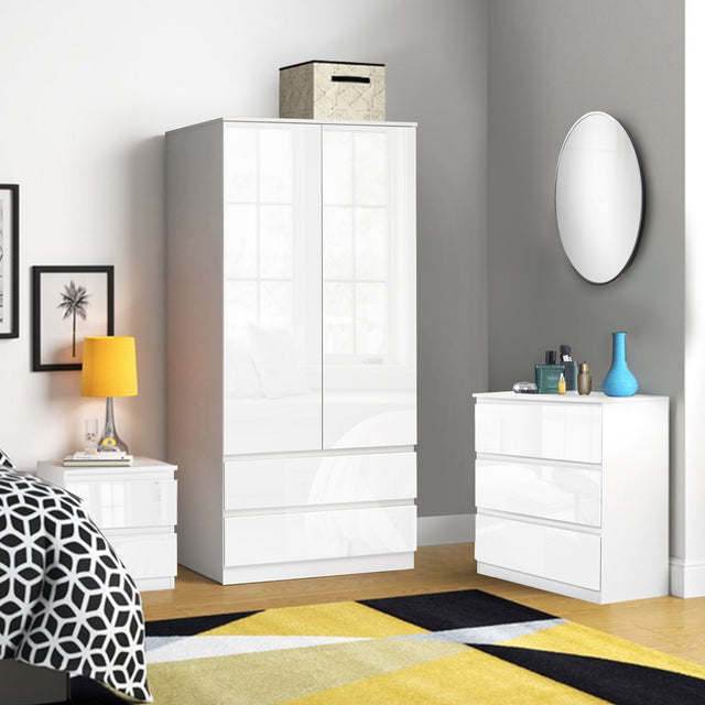 White bedroom furniture set, elegant and modern, including wardrobe, drawers, and bedside tables.