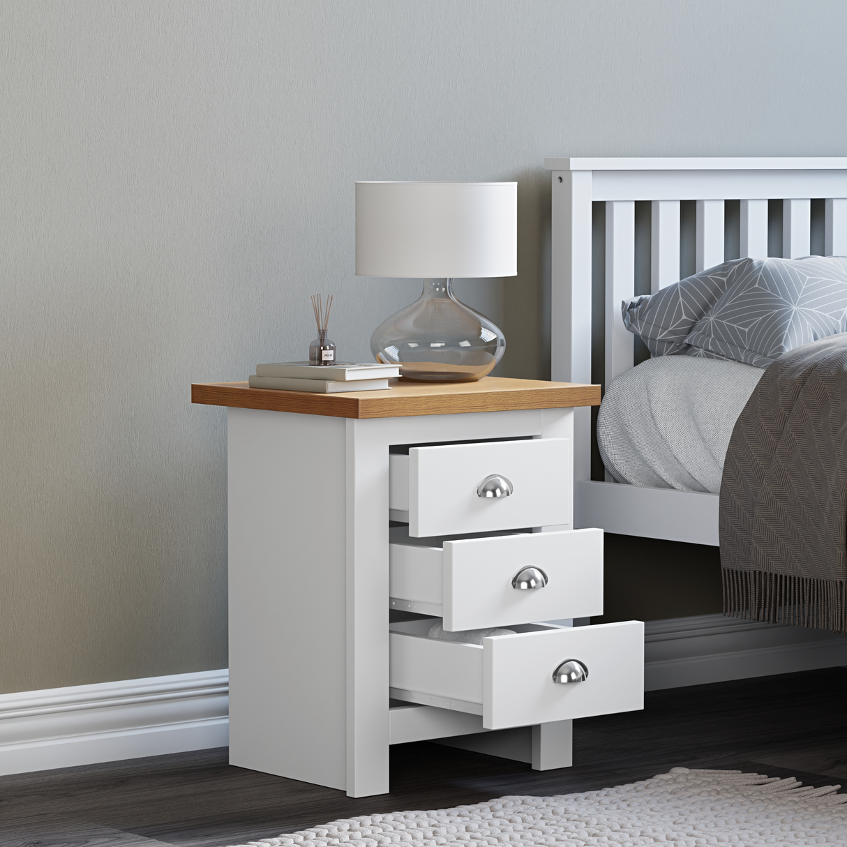 White bedside table with oak top, open drawers, and a surface perfect for books and decor.