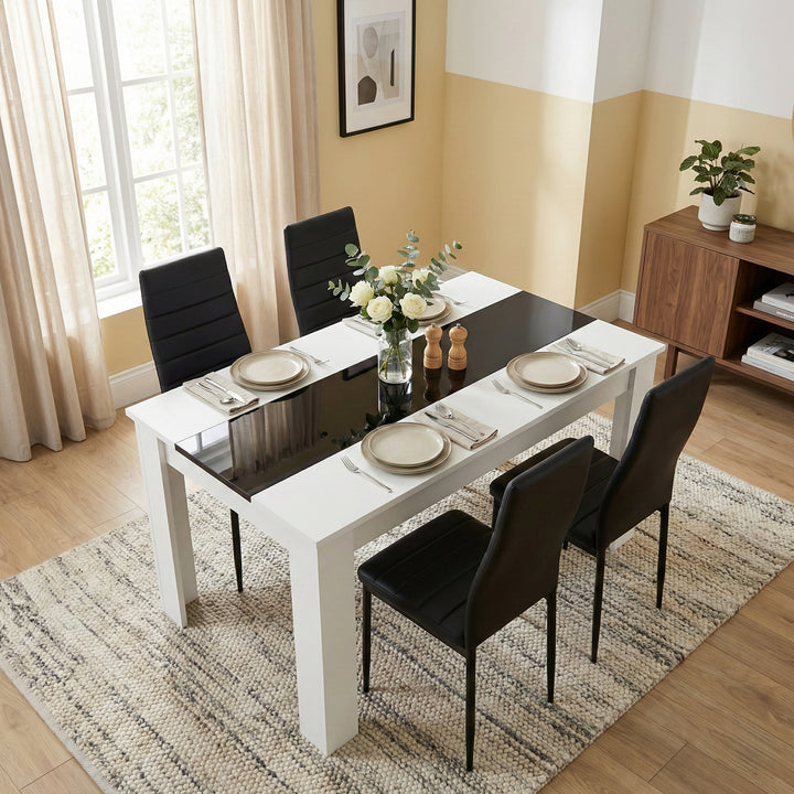 [4 Seater | Black] White & Black Gloss 4-6 Seater Dining Table viewed from above with four black faux-leather chairs and neutral place settings on a woven rug