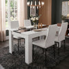 [4 Seater | White] White & Black Gloss 4-6 Seater Dining Table with four white faux-leather chairs and a rose centrepiece on a dark shag rug beneath 
