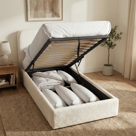 Single white boucle ottoman bed lifted to reveal under-bed storage compartment beneath the slatted mattress base