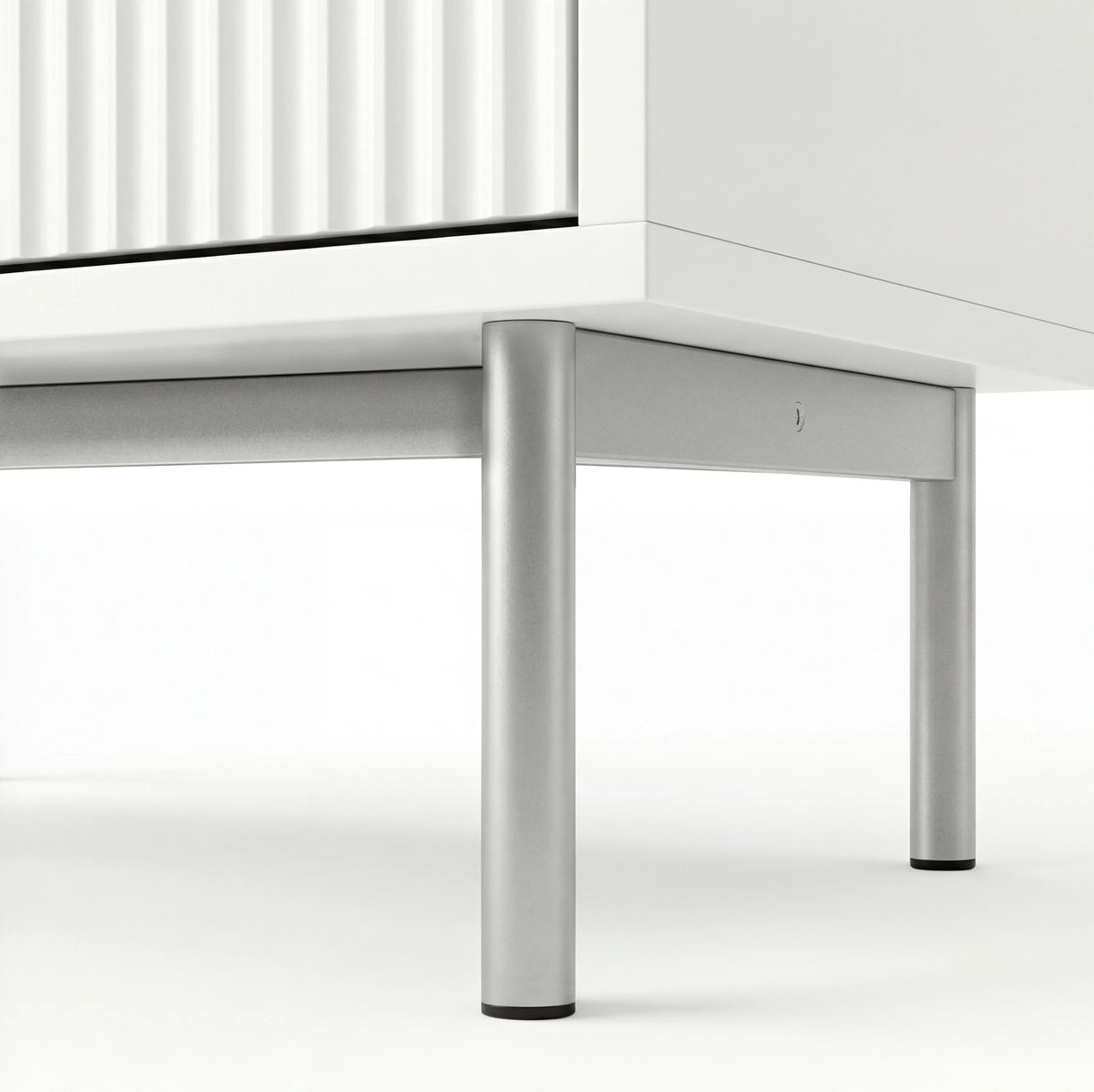 White chest of drawers base detail highlighting silver metal legs and elevated frame design