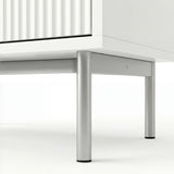 White chest of drawers base detail highlighting silver metal legs and elevated frame design
