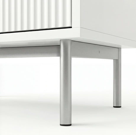 White chest of drawers base detail highlighting silver metal legs and elevated frame design