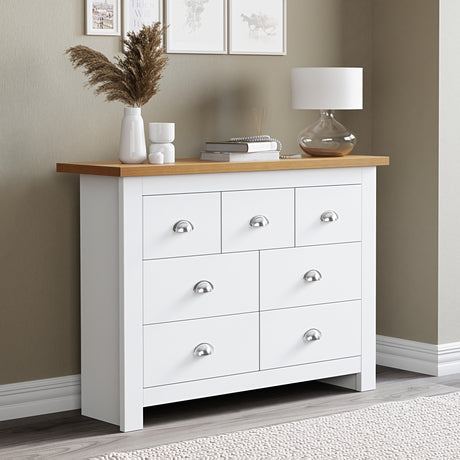 White chest of draws with handles, modern design and ample storage for bedroom essentials.
