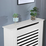 White covers for radiator pipes with horizontal slats and top smooth.