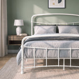 [White | Double] White metal bed frame with curved rails and white bedding, shown at a 3/4 Angle in bright bedroom.
