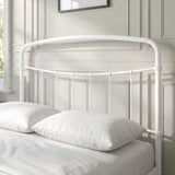 [White | Double] Close-up of the white curved headboard with vertical bars, white pillows and cream bedding.