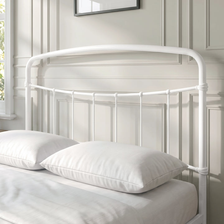 [White | Double] Close-up of the white curved headboard with vertical bars, white pillows and cream bedding.