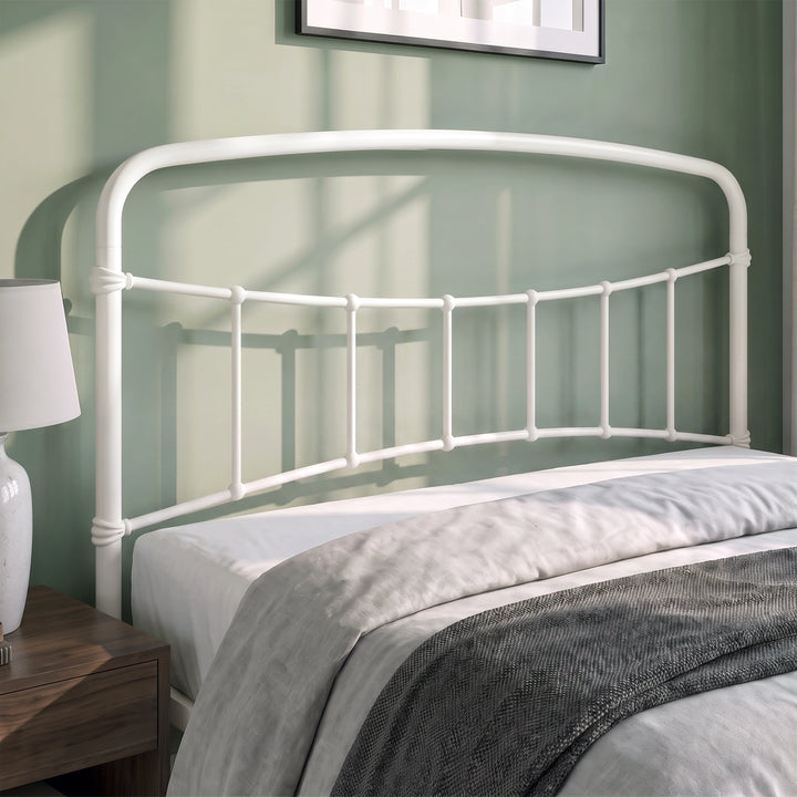 [White | Double] Close-up of the white curved headboard with vertical bars, white pillows and cream bedding.