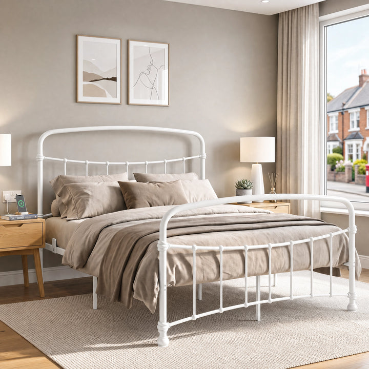 [White | King] White metal bed frame with taupe bedding, shown at a 3/4 Angle in a bright bedroom with a rug.