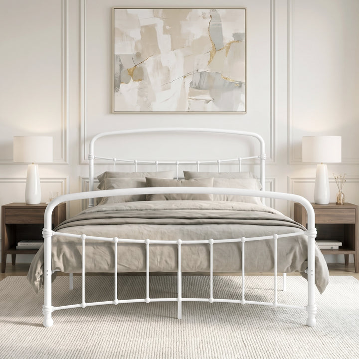 [White | King] Front view of a white metal bed frame with curved rails and taupe bedding in a bright bedroom.