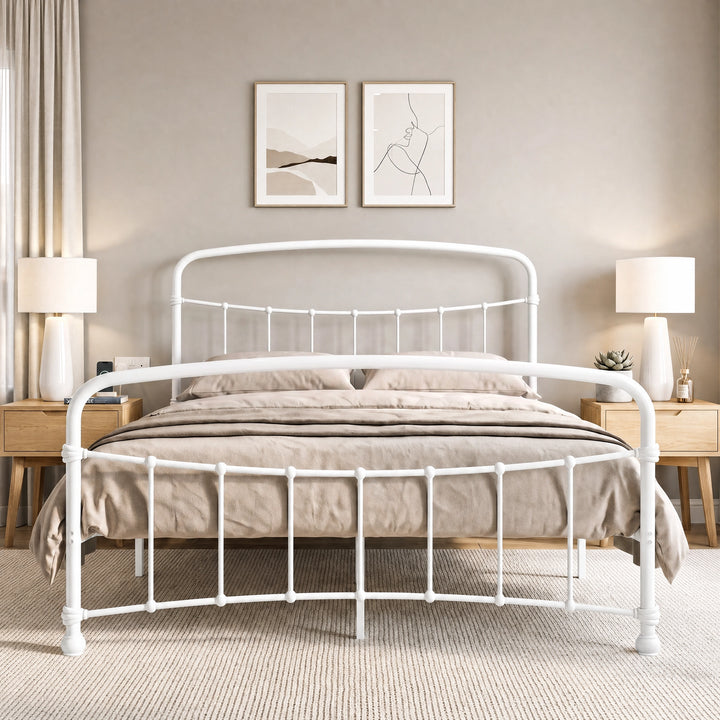 [White | King] Front view of a white metal bed frame with curved rails and taupe bedding in a bright bedroom.