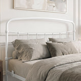 [White | King] Close-up of the white curved headboard with vertical bars, taupe pillows and layered bedding.