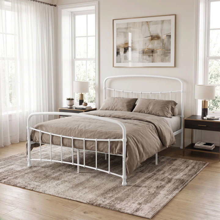 [White | King] White metal bed frame with taupe bedding, dark side tables and a large rug in a bright bedroom.