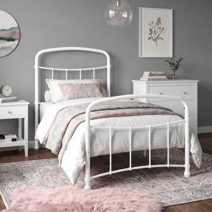[White | Single] White metal bed frame with white bedding, shown at a 3/4 Angle in a bright bedroom with a rug.