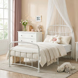 [White | Single] White metal bed frame with light bedding, soft toys and canopy netting in a child bedroom.