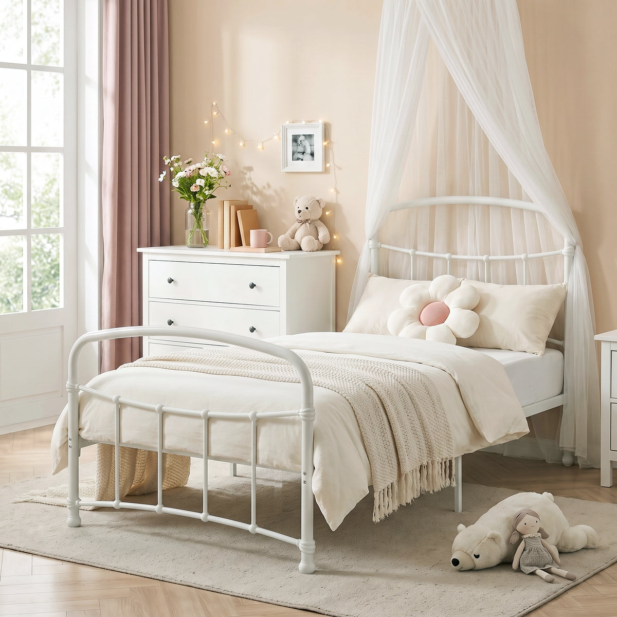 [White | Single] White metal bed frame with light bedding, soft toys and canopy netting in a child bedroom.