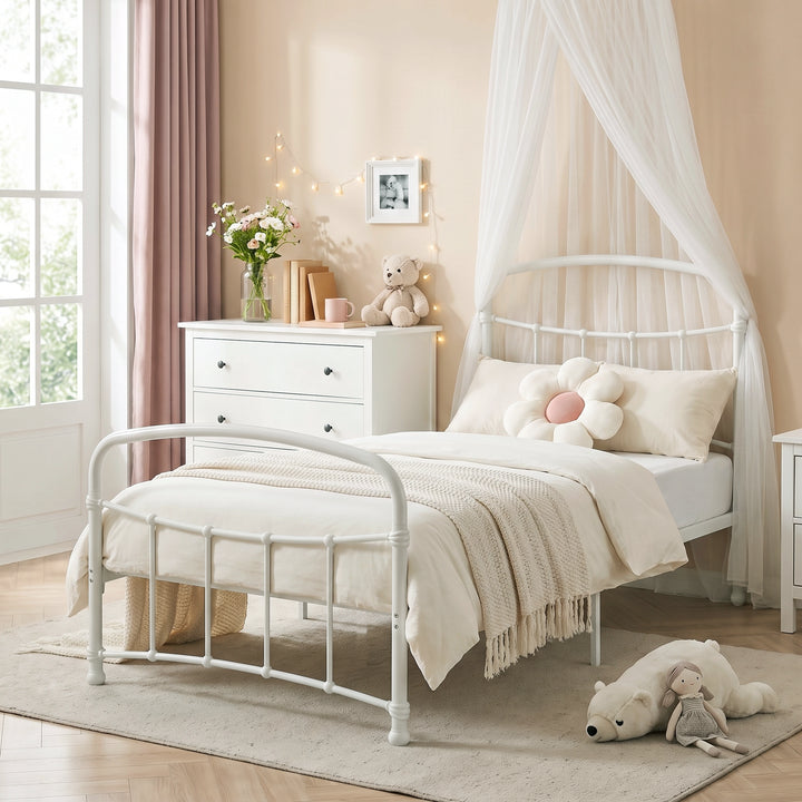 [White | Single] White metal bed frame with light bedding, soft toys and canopy netting in a child bedroom.