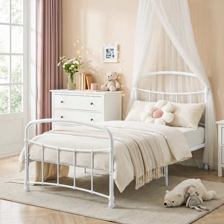 [White | Single] White metal bed frame with light bedding, soft toys and canopy netting in a child bedroom.