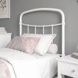 [White | Single] Close-up of the white curved headboard with vertical bars, white pillows and light bedding.