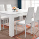 White dining table with matching chairs, perfect for elegant and modern dining.