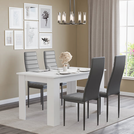4-seater white dining table and grey chairs set in a modern dining room with neutral tones and wall decor. Great for compact spaces.