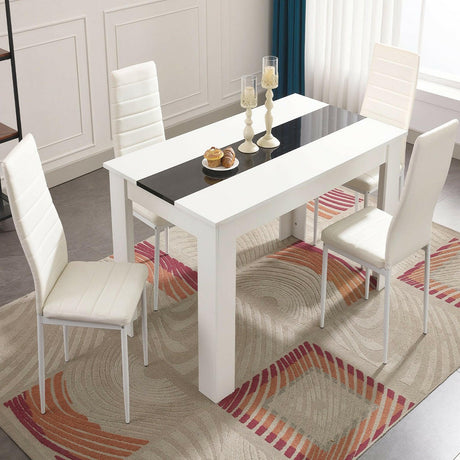 White dining table set with sleek design, perfect for contemporary dining spaces.