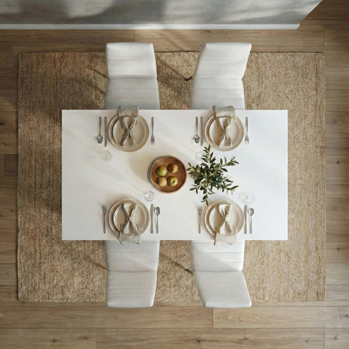 [4 Seater | White] White 4-6 Seater Dining Table and Chairs Set aerial overhead look at a minimalist four-person dinner arrangement with white plates, cloth napkins, and center