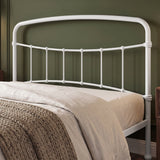 [White | Double] Headboard close-up showing curved top rail, vertical bars, rounded joints, bedding, and a knitted throw.