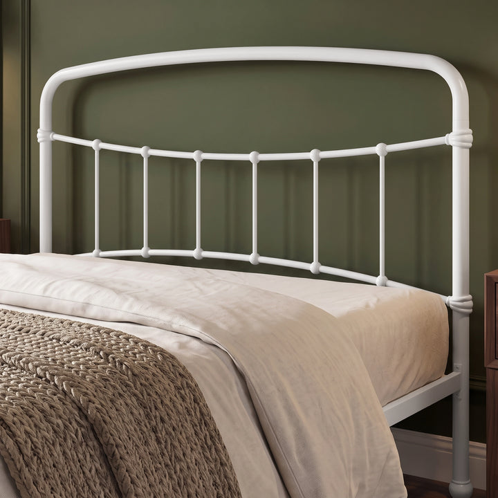 [White | Double] Headboard close-up showing curved top rail, vertical bars, rounded joints, bedding, and a knitted throw.