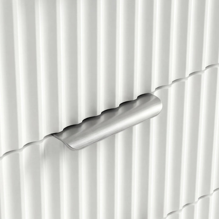 [White] Close view of silver metal handle on white flutrina front of chest of drawers in a natural light