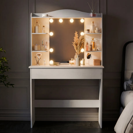 White vanity with mirror and lights in a bedroom setting