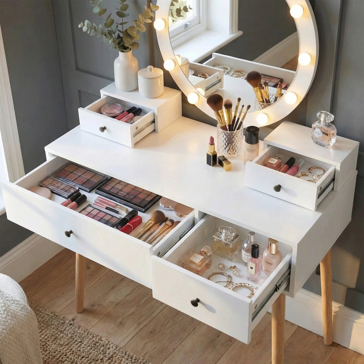 [White] Dressing table with all drawers open showing organised makeup accessories and brushes on tabletop