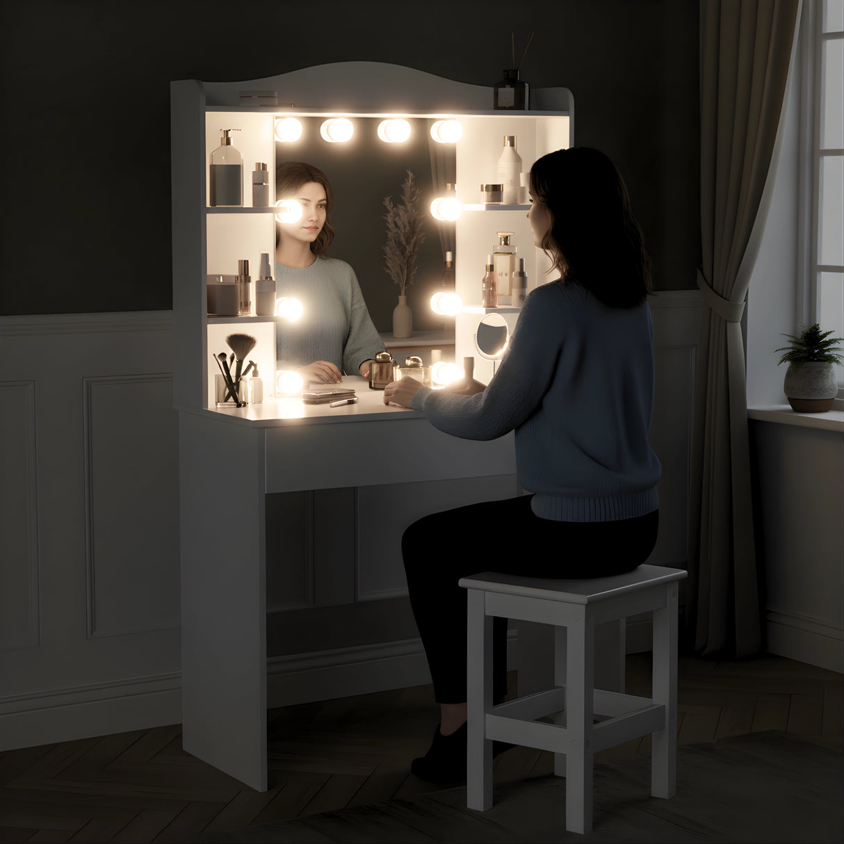 Woman sitting at a vanity mirror with lights in a dimly lit room