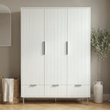 [White] Flutrina three door wardrobe front view with fluted panels, silver handles, three drawers and slim metal legs