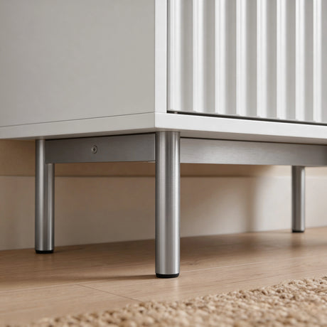 [White | 60cm] Flutrina close-up of silver cylindrical legs and base frame beneath the white cabinet on a wooden floor