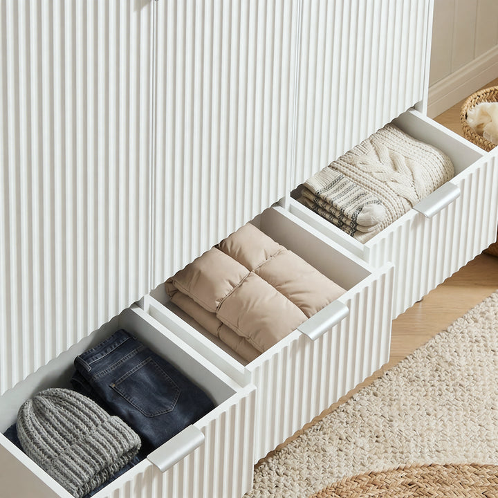 [White] Flutrina wardrobe three drawers pulled open revealing folded knitwear, rolled garments and neatly stacked jeans