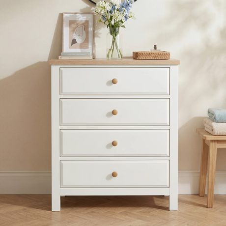 [White] Haven 4 drawer chest styled with blue florals, a framed art print and a wicker tray on the oak top surface