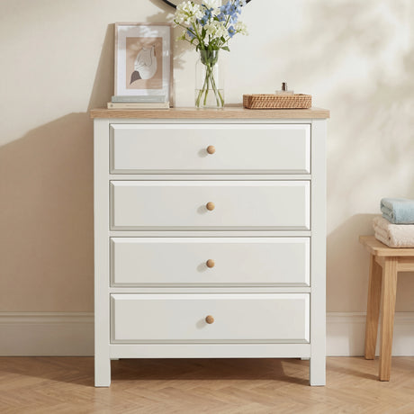 [White] Haven 4 drawer chest styled with blue florals, a framed art print and a wicker tray on the oak top surface