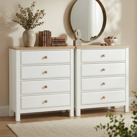 [White] Haven 4 drawer chest shown as a matching pair side by side, styled with eucalyptus stems, books and a round mirror